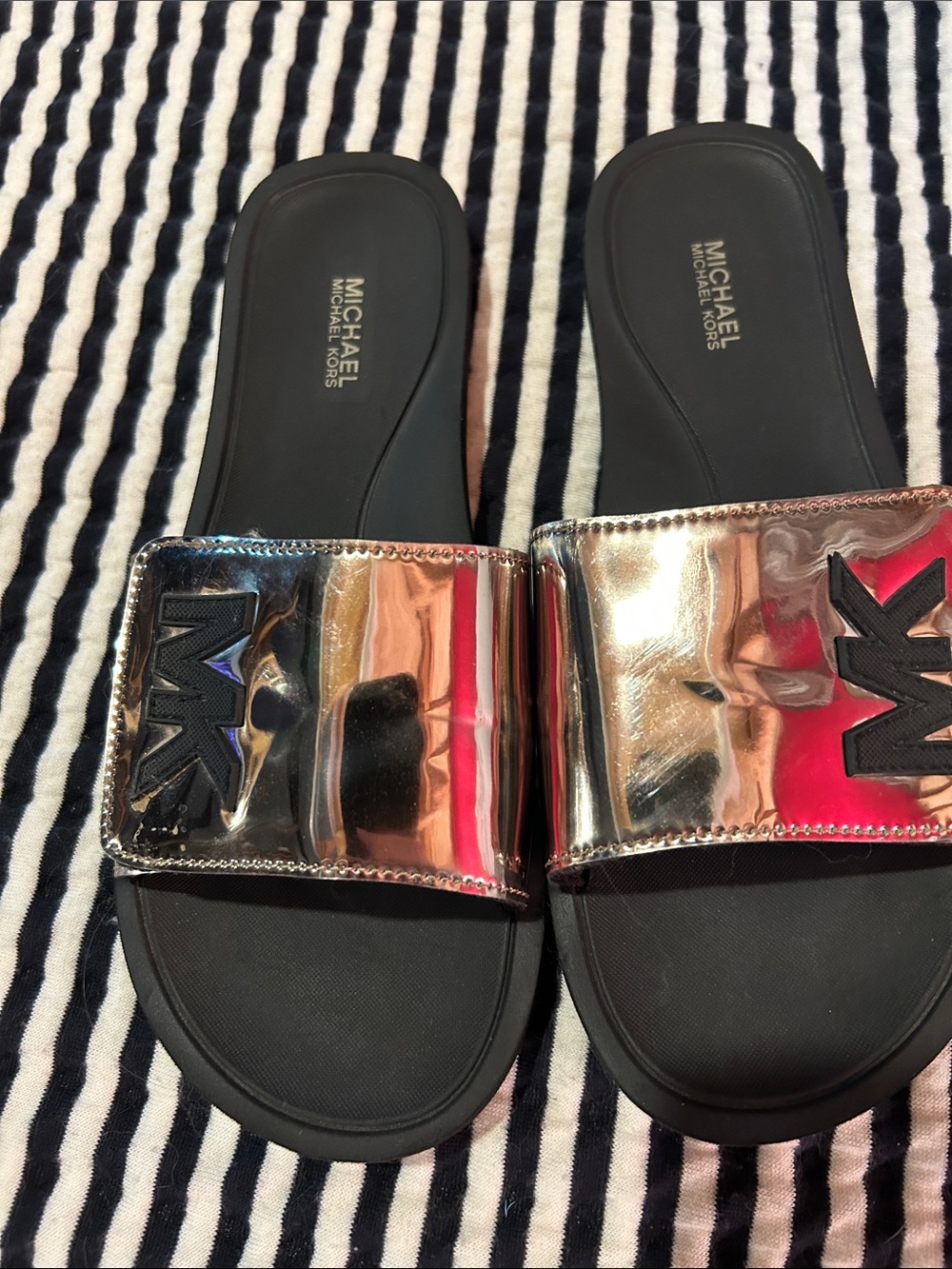 Michael Kors women’s Metallic Rose Gold Slide Sandals with Black Footbed